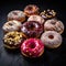 Colorful iced donuts on a slate