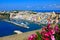 Colorful island town in Italy, view overlooking Procida from a flowery terrace