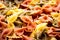 Colorful italian pasta farfalle tricolore abstract backdrop.