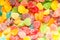Colorful jellies and candies sweets heart-shaped background