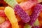 Colorful jelly marmalade worms, sweet delicious background. Light sweet dessert. Macro photo.