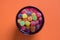 Colorful jujubes in glass bowl top view