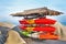 Colorful Kayaks and canoes in a Row stack
