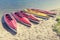 Colorful kayaks moored on lakeshore, Goldopiwo Lake, Mazury, Pol