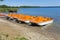 Colorful kayaks moored on lakeshore, Goldopiwo Lake, Mazury, Pol