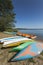 Colorful kayaks moored on lakeshore, Goldopiwo Lake, Mazury, Pol