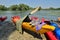 Colorful kayaks on riverbank
