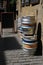 Colorful kegs of beer at the exit of a pub, on a brick wall