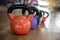 Colorful kettlebells in a row in a gym