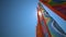 Colorful kite flying against a blue sky and sun