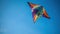 A colorful kite flying against a clear blue sky created with Generative AI