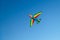 A colorful kite flying in the sky is a symbol of freedom and equality of free sexual people. Airplane in the blue sky