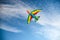 A colorful kite flying in the sky is a symbol of freedom and equality of free sexual people. Airplane in the blue sky