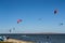 Colorful kiteboard parachutes in the sky. Kitesurfing, Kiteboarding, Kiteboarders competitions concept. Kitesurfers surfing the