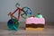 colorful knife cutter in shape bicycle on bright birthday piece of sponge cake, cut a cake