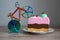 colorful knife cutter in shape bicycle on bright birthday piece of sponge cake, cut a cake