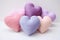 Colorful knitted hearts in pastel colors
