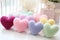 Colorful knitted hearts in pastel colors