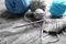 Colorful knitting yarn with unfinished clothes on table