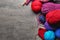 Colorful knitting yarn with unfinished clothes on table