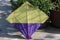 Colorful landed kite with partial view under bright daylight.