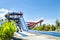 Colorful large slider at amusement water park or aquapark in beautiful cloudy and blue sky day