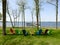 Colorful lawn chairs on green grass near lake shore