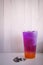 Colorful layer of pink and purple herb tea. Butterfly pea tea cold drink for refreshment