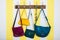 Colorful leather bags hanging on wooden wardrobe