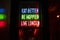 Colorful led and neon light sign where puts:`Eat better, Be happier, Live longer`.