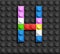Colorful letter H from building lego bricks on black lego background. Lego letter M