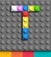 Colorful letter T from building lego bricks on gray lego background. Lego letter M