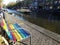 Colorful LGBT bench pride, canals and houses of Amsterdam city, in Holland, Netherlands