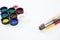 Colorful lids and paintbrushes on white background