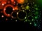 Colorful light bubbles Background. Neon rainbow bokeh effect. Dark background with Glowing sparkling circles and rings