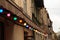 Colorful light bulbs. Classic architecture details. Old facade with light bulb. Decorative external lighting. Classic