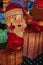 Colorful light decoration of Santa Claus raising his thumb up looking happy with piles of gift boxes