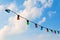 Colorful lightbulbs against blue sky