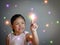 Colorful lights coming out from little girl fingertip; Concept of childhood, imagination, creativity, happiness, dream, adventure