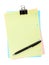 Colorful lined office paper with clip and pen