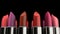 Colorful lipsticks with red tint on the makeup fashion cosmetic presentation