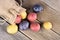 Colorful little potatoes spilling from burlap bag on rustic wood