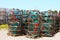 Colorful lobster cages stacked on pallets outside