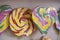 Colorful lollipop swirl of different forms on wooden stick