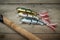 Colorful lures with the fishing rod on the wooden pier