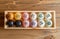 Colorful macarons on wooden tray