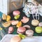 Colorful macaroon cakes on a vintage wooden table
