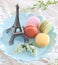 Colorful macaroons on blue plate