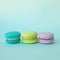 Colorful macaroons on a blue textural square background