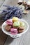 Colorful macaroons in a bowl, lavender